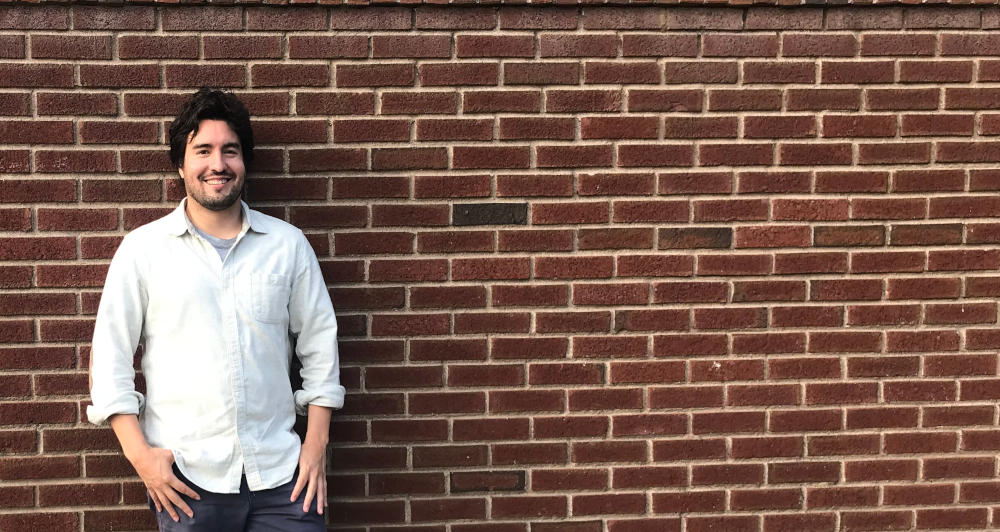 David in front of a brick wall